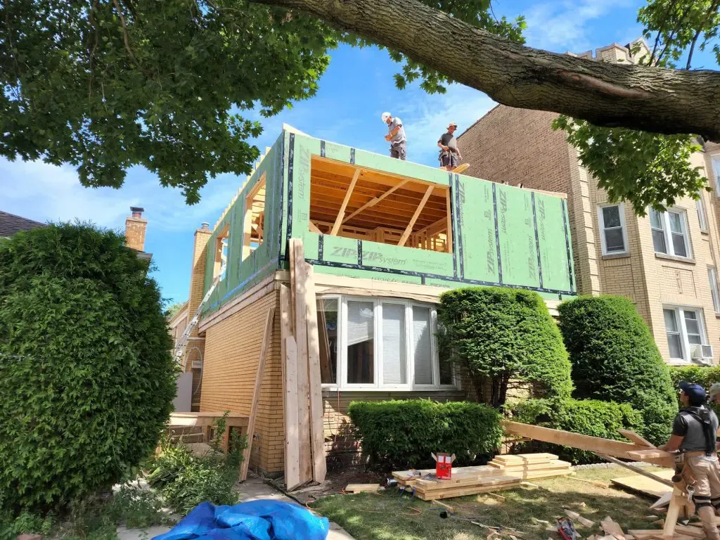 Three-season sunroom addition framing tied into existing home